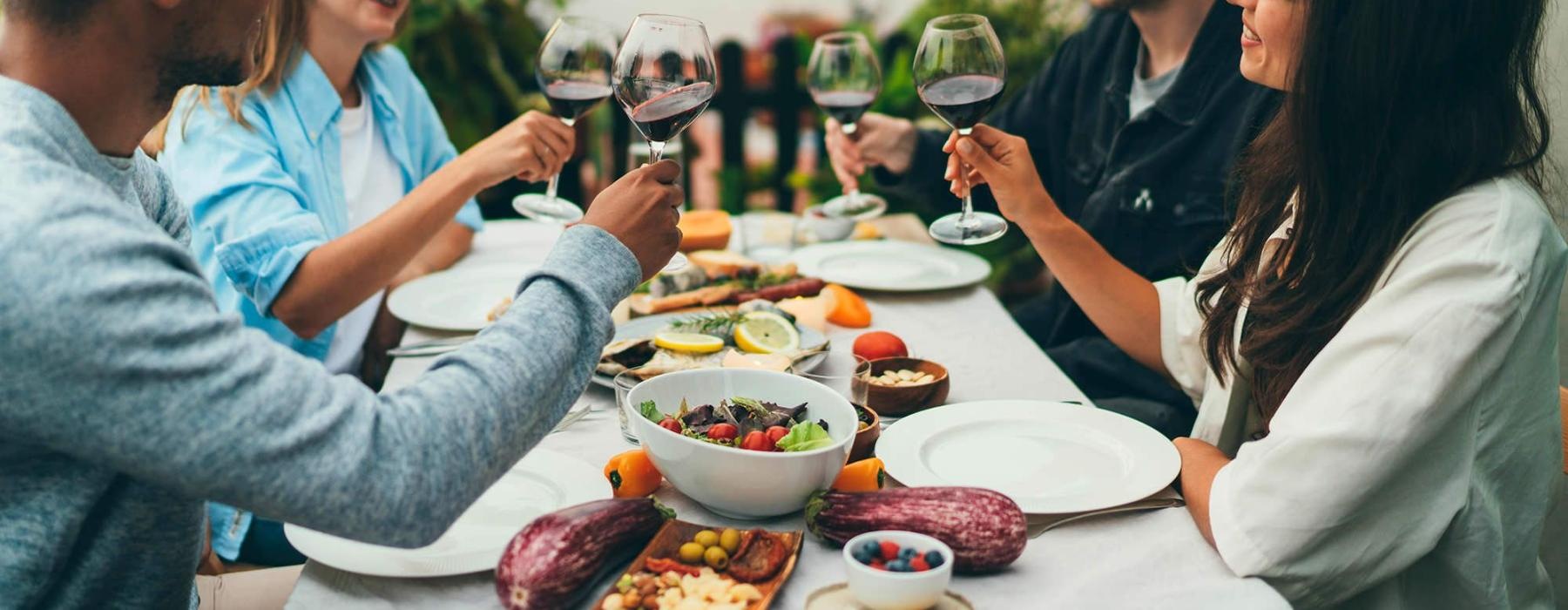 a group of people having a meal around an outdoor table